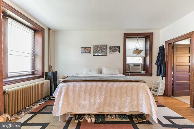 a living room with a bed furniture and a window