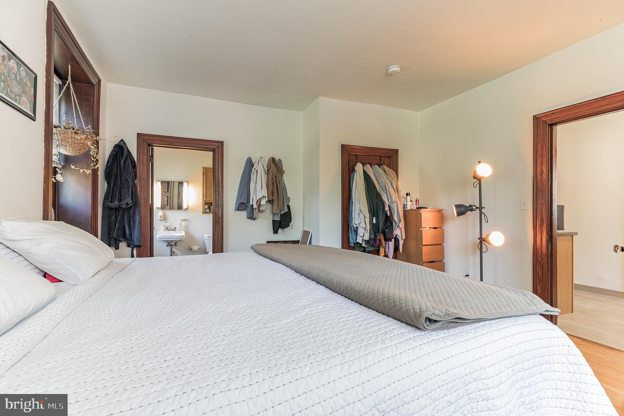 1320 Butler Pike, Unit 2 Conshohocken, PA 19428 - Photo 14 of 18 a bedroom with a large bed and a large mirror