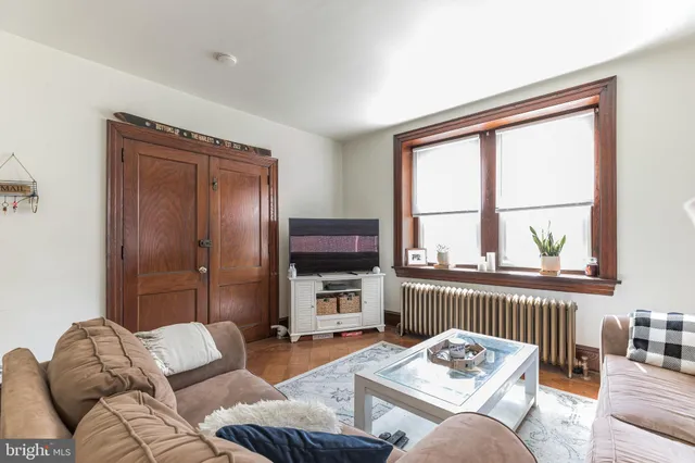 a living room with furniture a rug and a window