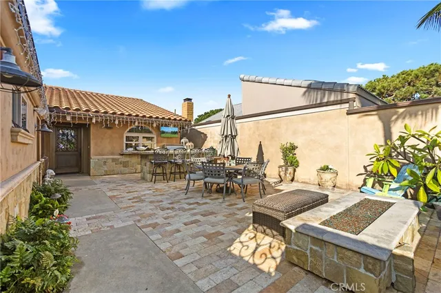 a view of a patio with table and chairs and potted plants