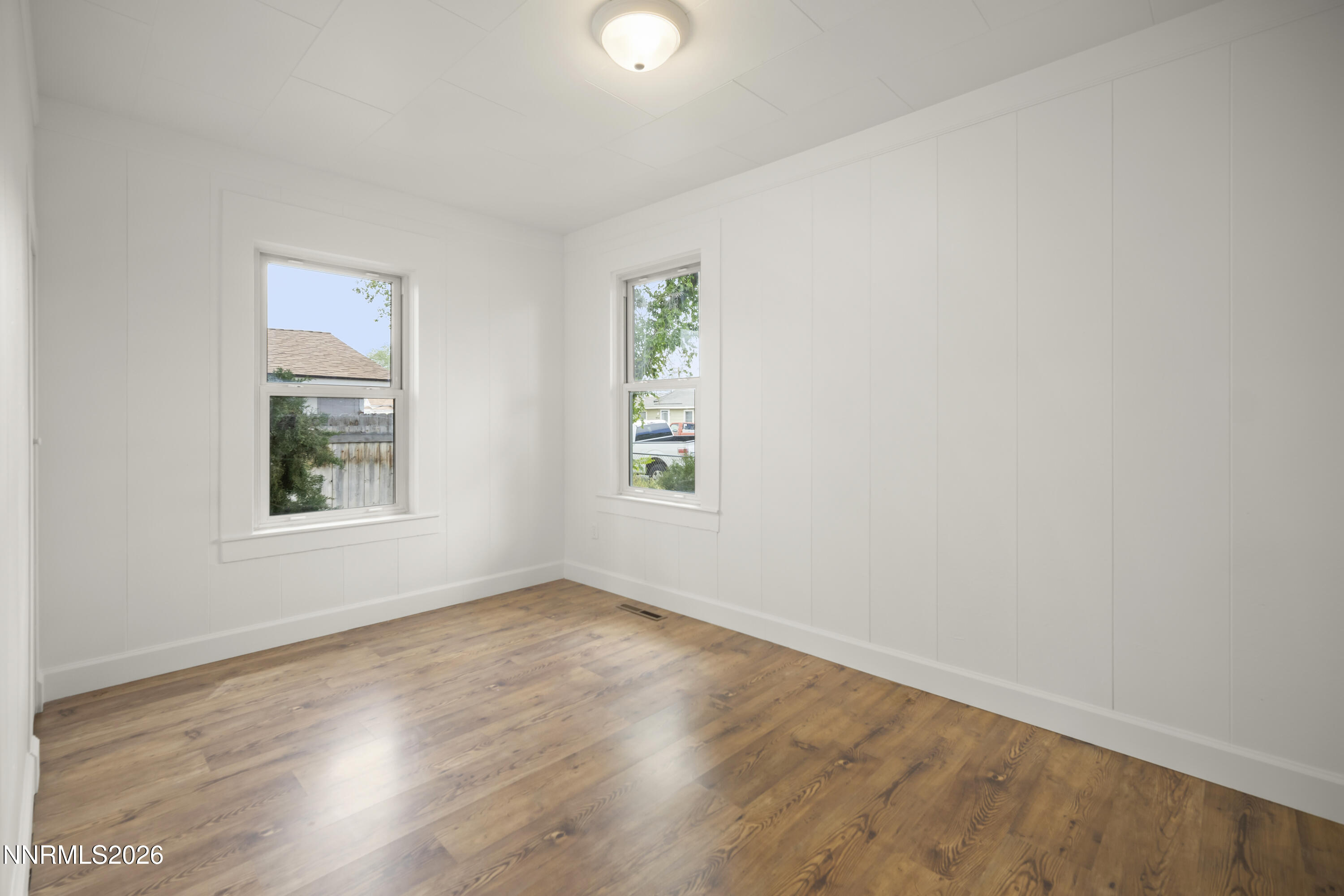 511 Churchill Street Fallon, NV 89406 - Photo 19 of 37 an empty room with wooden floor and windows