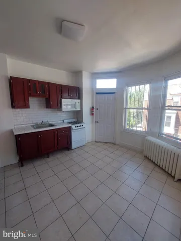 a spacious bathroom with a granite countertop bathtub sink and cabinets