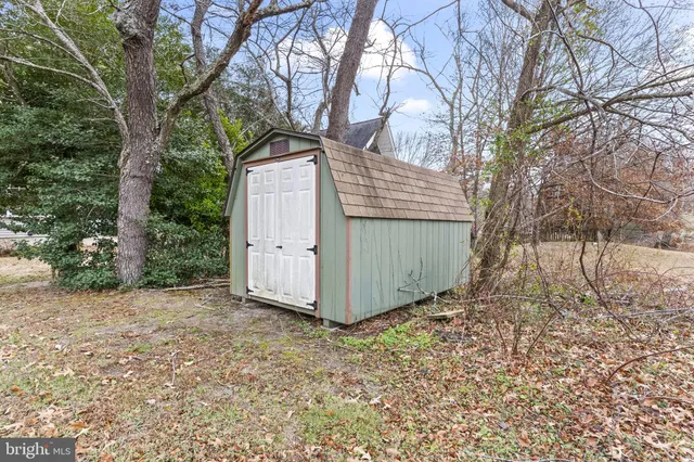 a view of a house with a backyard and chairs