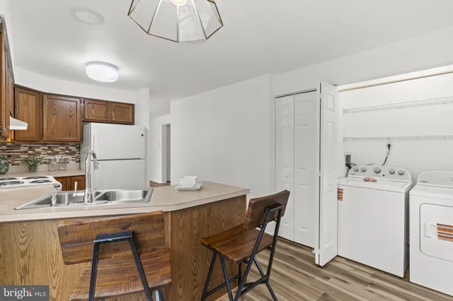a room with stainless steel appliances kitchen island a table and chairs in it