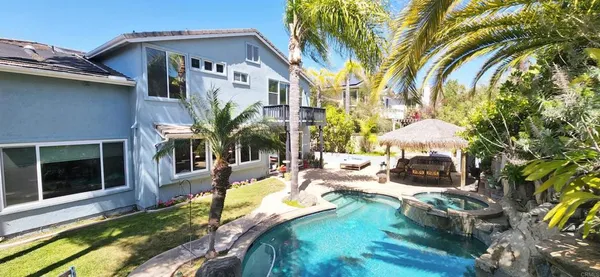 a view of a house with backyard porch and sitting area