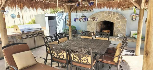 a view of a dining room with furniture a chandelier and wooden floor
