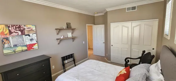 a bedroom with a bed and cabinets