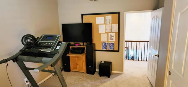 a view of a hallway with workspace and a window