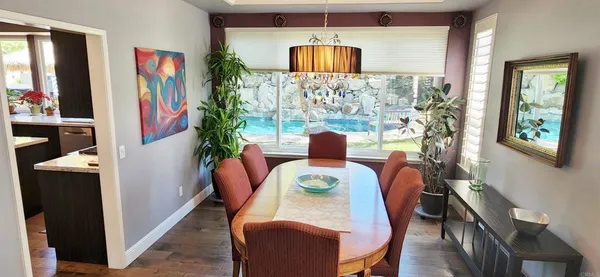 a dining room with furniture and a large window