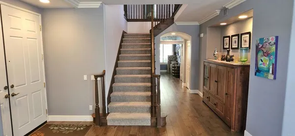 a view of entryway and hall with wooden floor