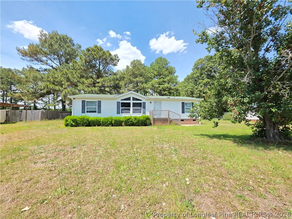 124 Franklin Road Raeford, NC 28376 - Photo 1 of 15 a front view of a house with garden