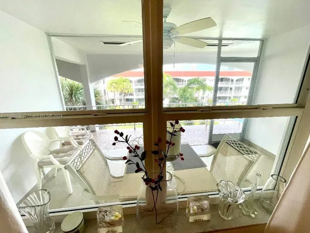 a view of living room with furniture and floor to ceiling window