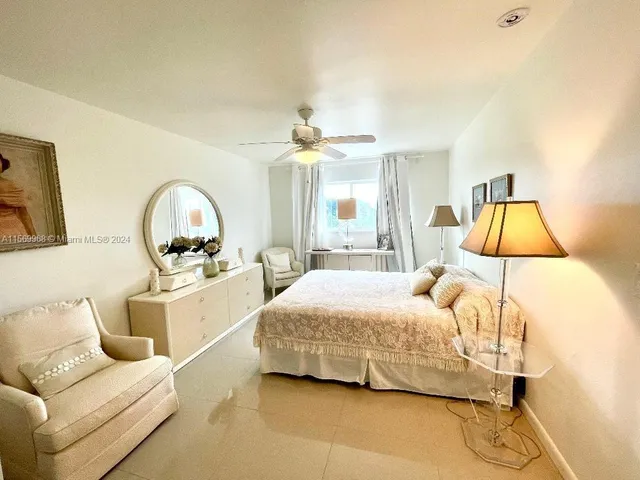 a bedroom with a bed couch and window