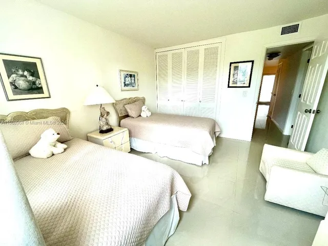 a bedroom with double bed and a couch