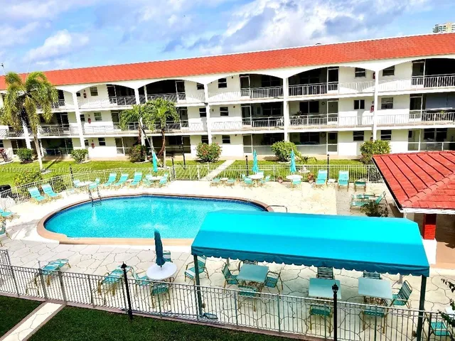 a front view of a building with a garden