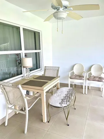 a view of a dining room with furniture and a chandelier fan
