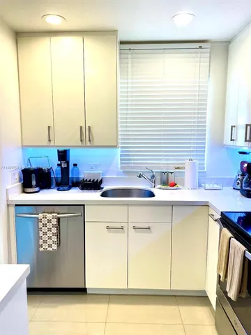a kitchen with stainless steel appliances granite countertop a sink and a cabinets