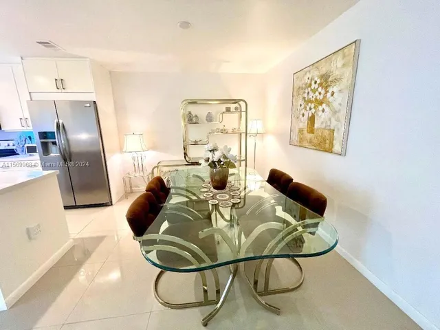 a view of a dining room with furniture a rug and wooden floor