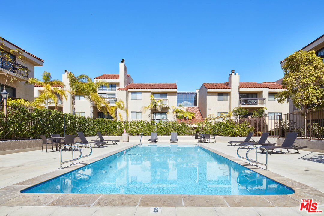 a view of a swimming pool with outdoor seating