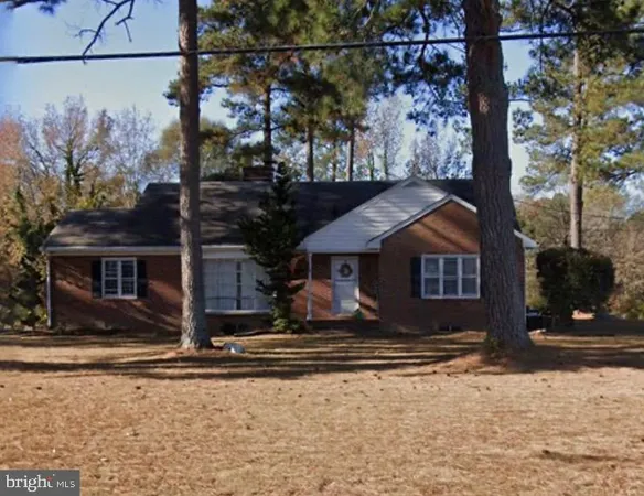 a view of a house with a yard covered in snow