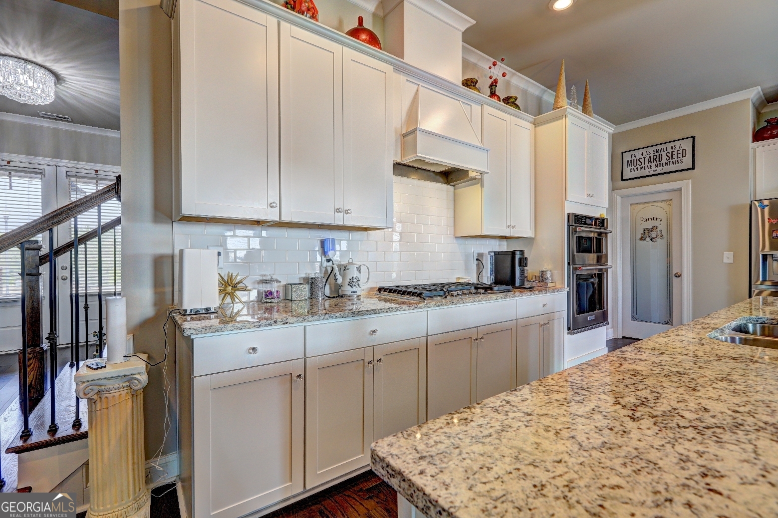 1522 Windward Locust Grove, GA 30248 - Photo 16 of 76 a kitchen with kitchen island granite countertop a sink cabinets stainless steel appliances and a counter top space