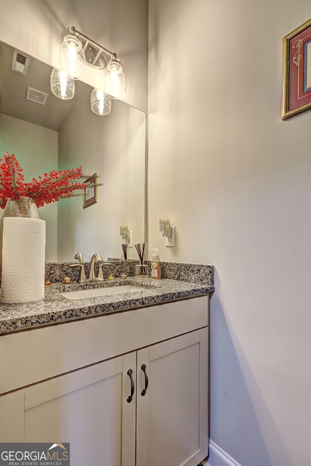 1522 Windward Locust Grove, GA 30248 - Photo 52 of 76 a bathroom with a granite countertop sink and a mirror