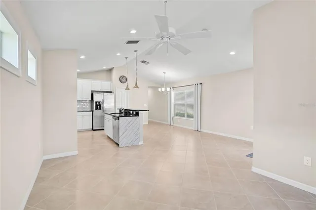 a living room with furniture kitchen and a dining table
