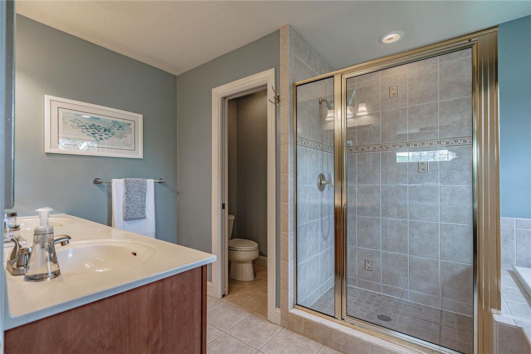 6000 Pond View Terrace Bath, PA 18014 - Photo 39 of 69 A well-appointed bathroom offers a dual vanity, a tiled walk-in shower, and a private commode area.