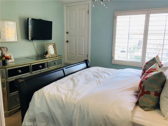a bedroom with a bed and a flat screen tv