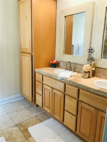 a bathroom with a double vanity sink and a mirror