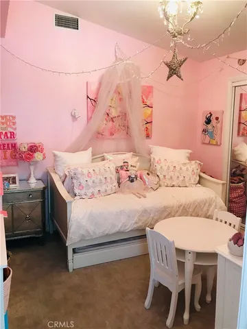 a bedroom with a bed and a dresser