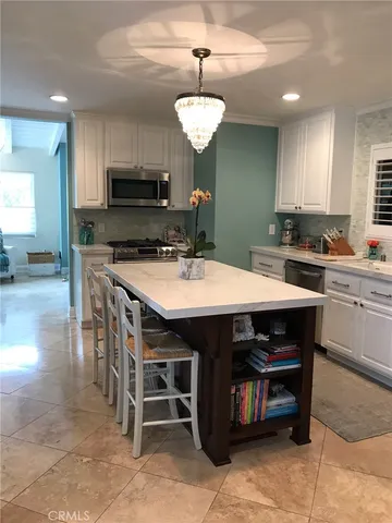 a kitchen with a wooden table chairs and a stove