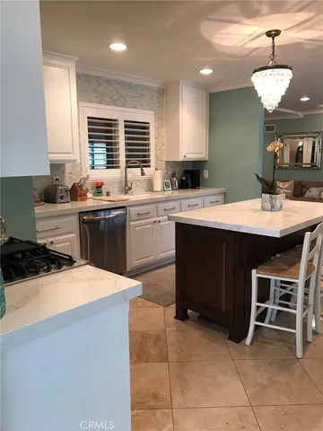 a kitchen with a sink a stove a dining table and chairs