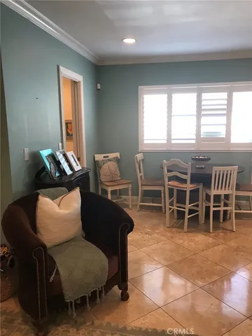 a work room with furniture a window and a potted plant