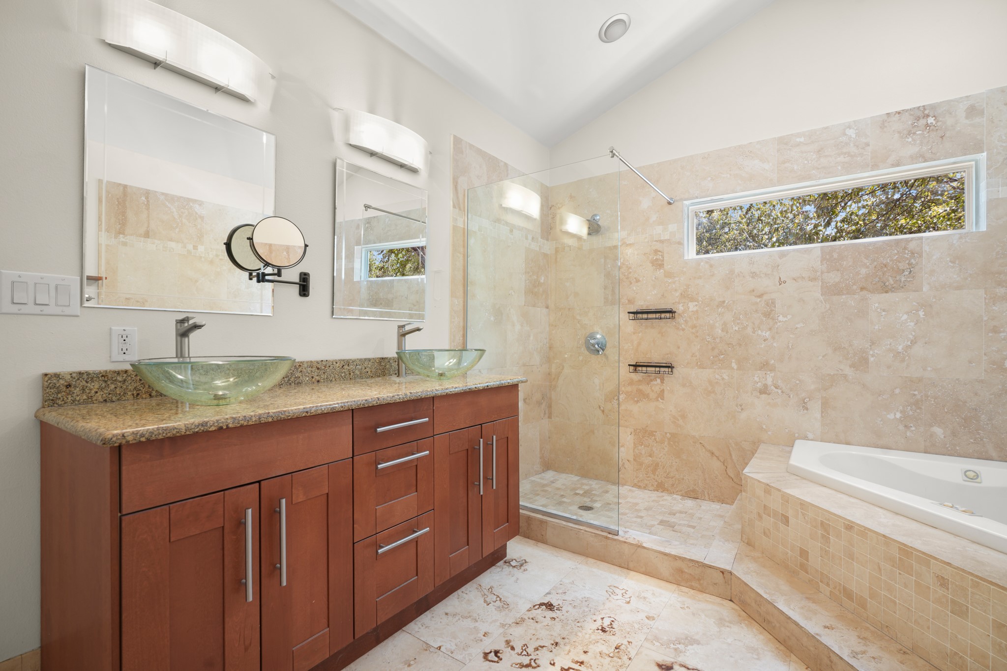 2501 Del Curto Road Austin, TX 78704 - Photo 17 of 26 A tiled walk-in shower and separate soaking tub anchor this spacious main bathroom.