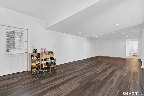 a view of a room with wooden floor and furniture