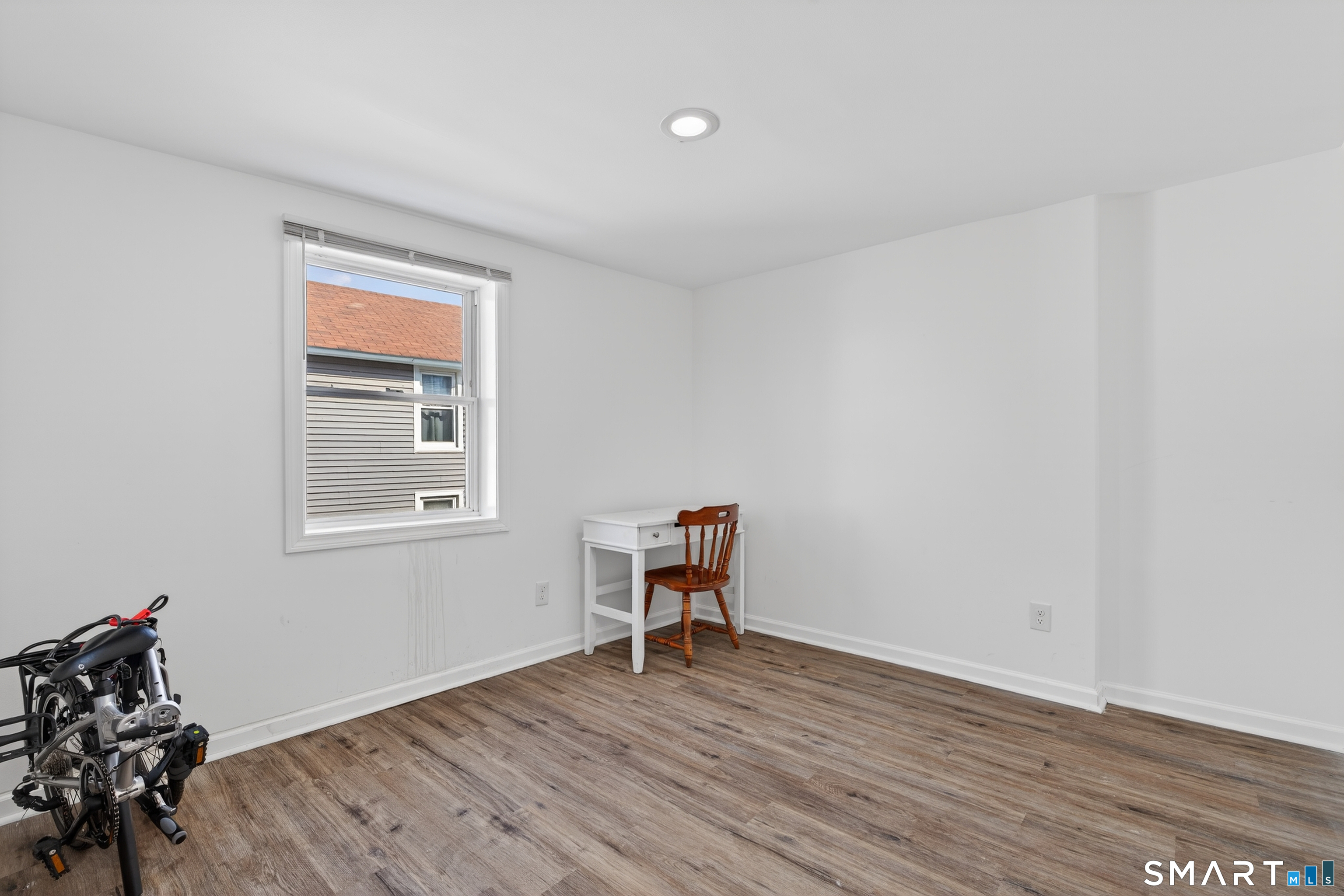 720 Baldwin Street Waterbury, CT 06706 - Photo 15 of 40 a view of a room with wooden floor lounge chair and windows