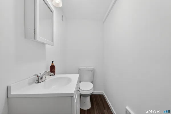 a bathroom with a sink a toilet and mirror
