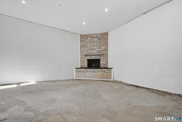 a view of an empty room with a fireplace