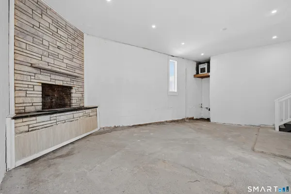a view of an empty room with a fireplace