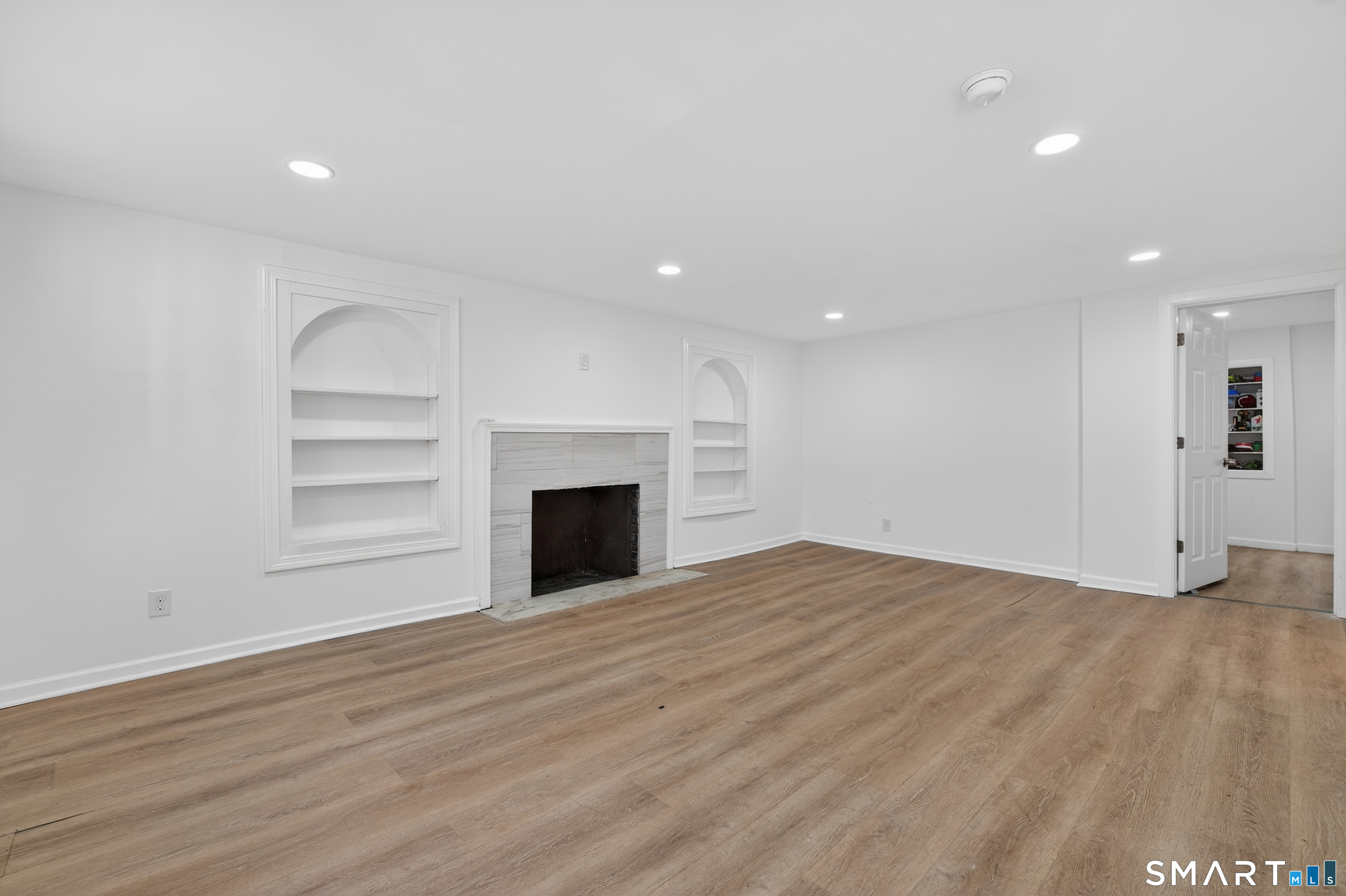 720 Baldwin Street Waterbury, CT 06706 - Photo 21 of 40 a view of empty room with wooden floor and fireplace