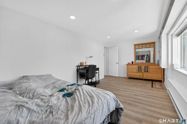 a bedroom with a bed and a chair