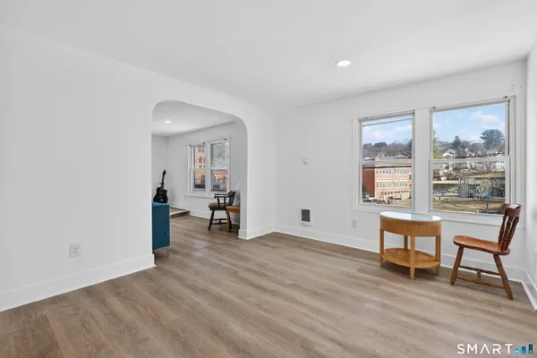 a view of a room with wooden floor and a window