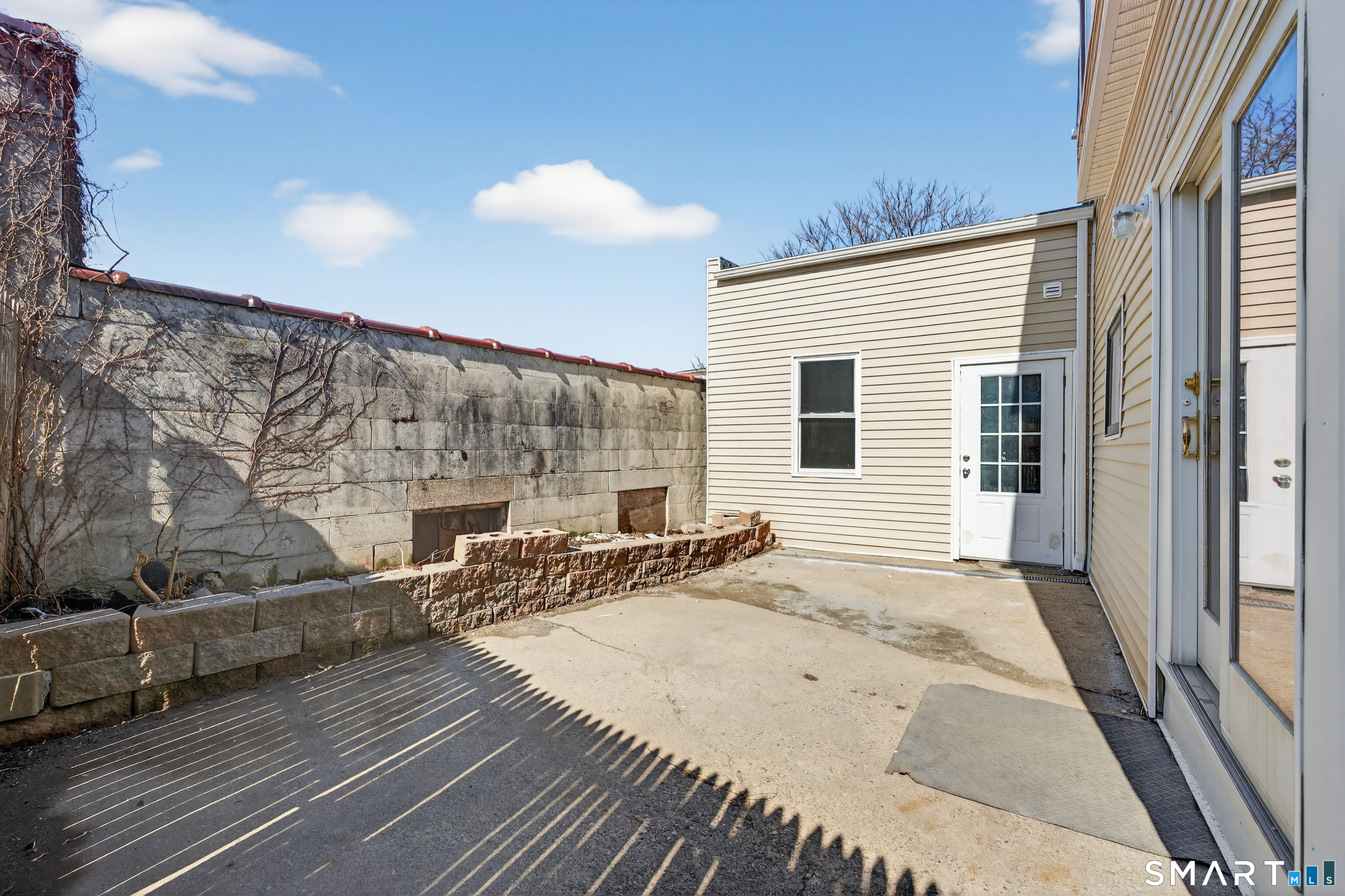 720 Baldwin Street Waterbury, CT 06706 - Photo 34 of 40 a view of a patio with couches and table and chairs with wooden floor