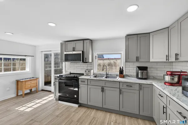 a kitchen with stainless steel appliances a sink stove and cabinets