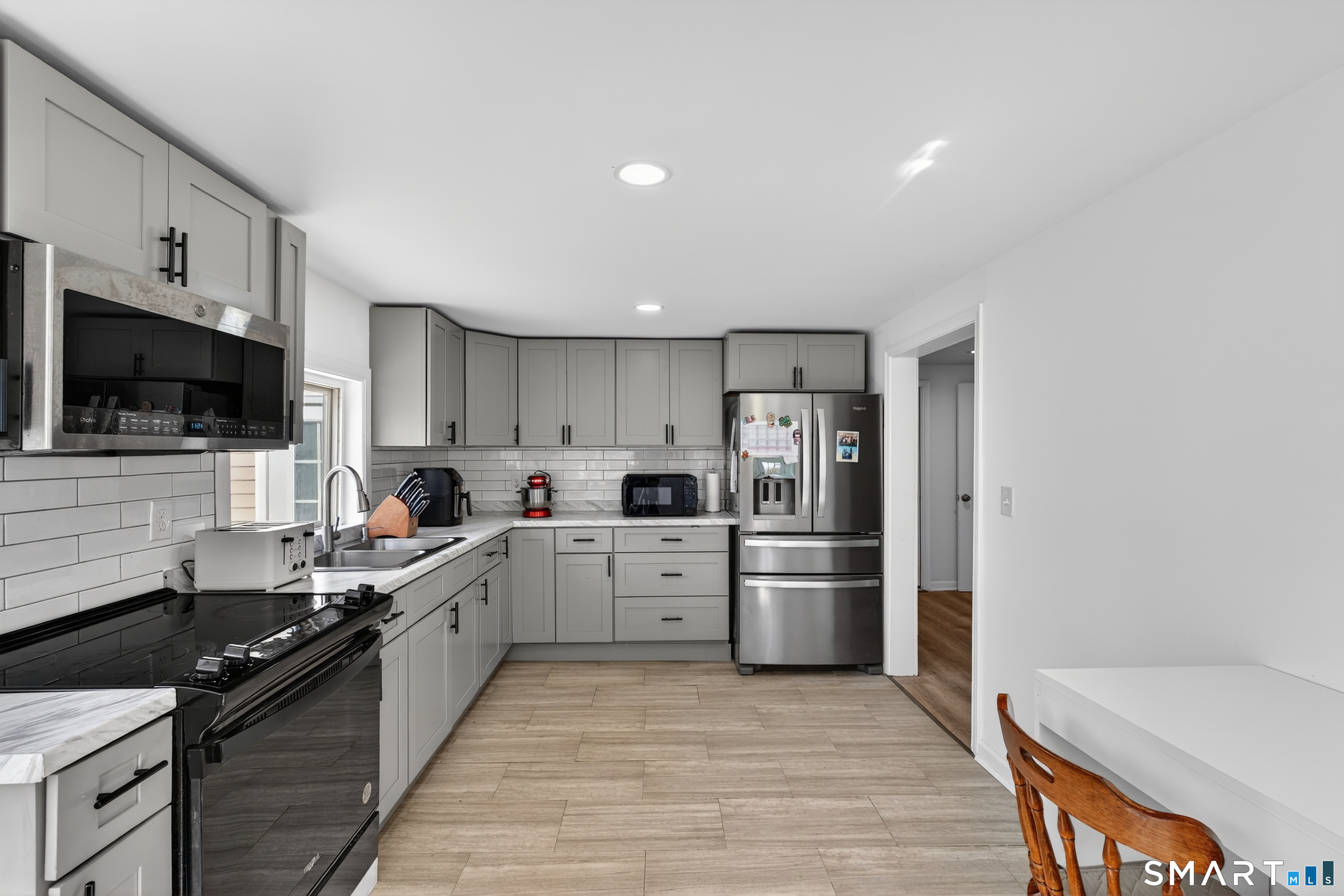 720 Baldwin Street Waterbury, CT 06706 - Photo 5 of 40 a large kitchen with a stove and a refrigerator