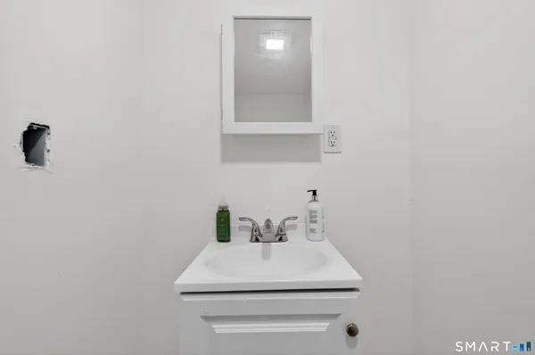 a bathroom with a sink a vanity and mirror
