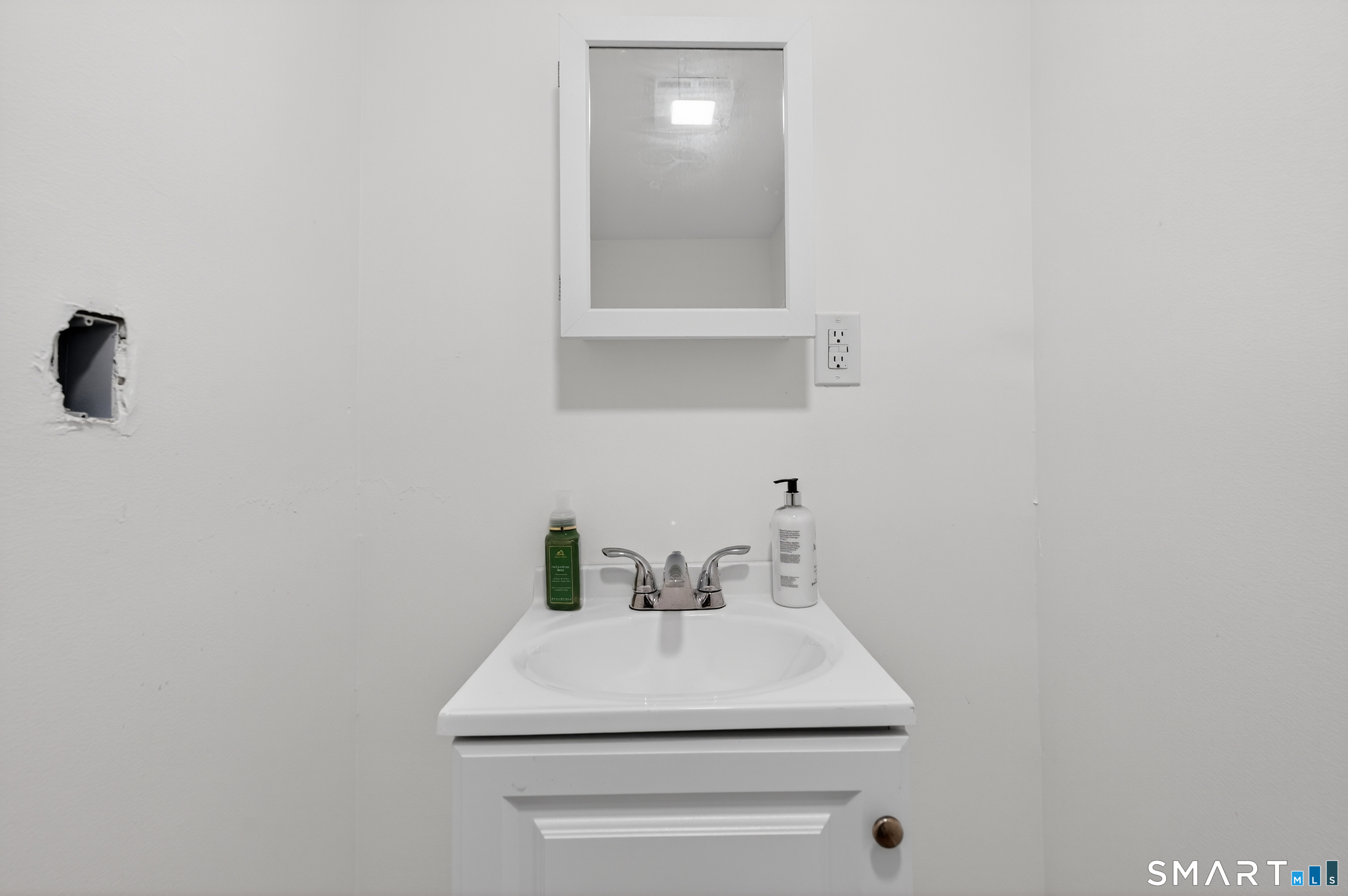 720 Baldwin Street Waterbury, CT 06706 - Photo 8 of 40 a bathroom with a sink a vanity and mirror
