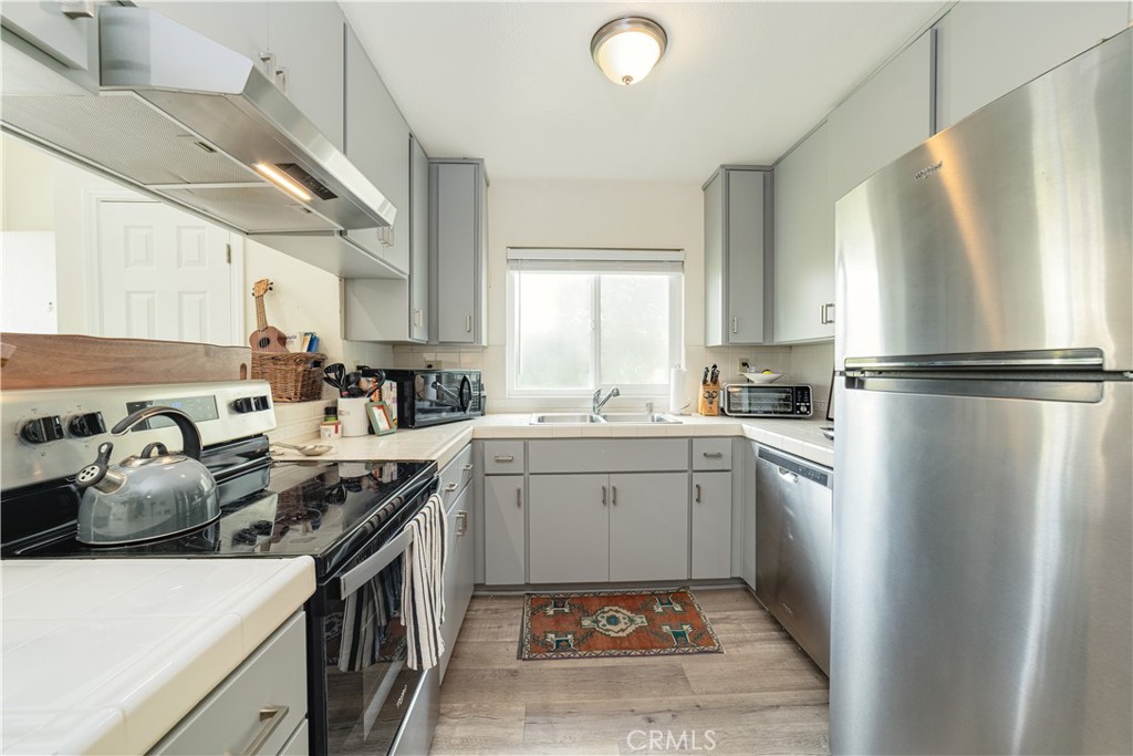 34028 Selva Road, Unit 75 Dana Point, CA 92629 - Photo 16 of 45 a kitchen with a sink stainless steel appliances and white cabinets