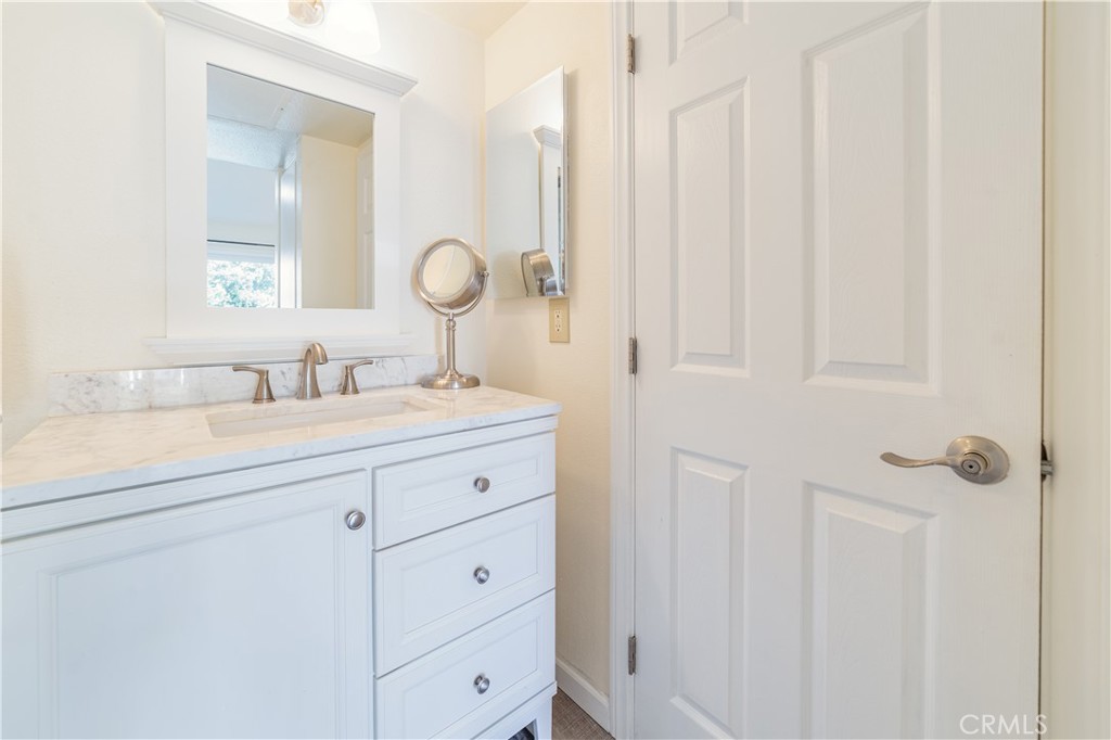 34028 Selva Road, Unit 75 Dana Point, CA 92629 - Photo 24 of 45 a bathroom with a sink vanity and a mirror